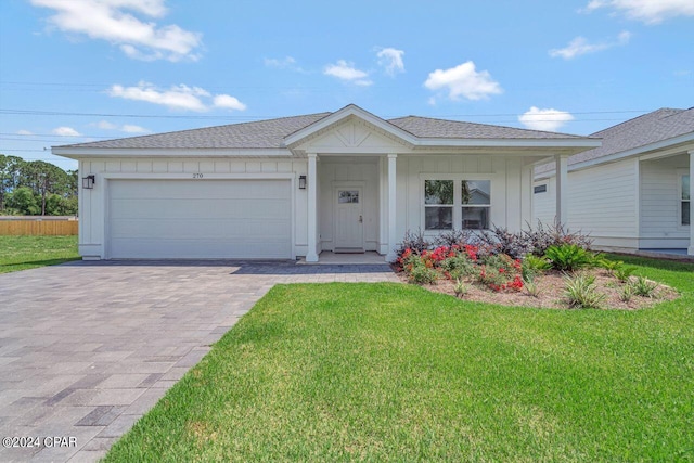 ranch-style house with a garage and a front lawn