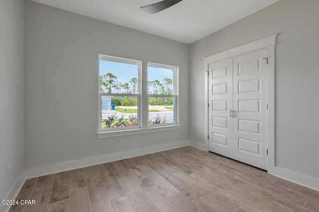 spare room with ceiling fan and light hardwood / wood-style floors