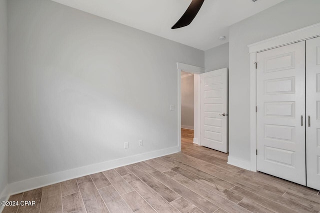 unfurnished bedroom featuring a closet, ceiling fan, and light hardwood / wood-style flooring