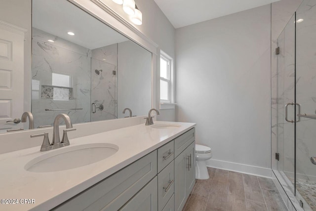 bathroom with vanity, toilet, wood-type flooring, and walk in shower