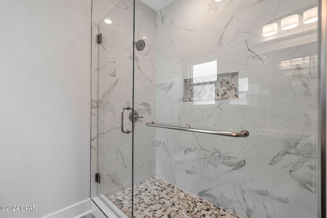 bathroom with a shower with shower door