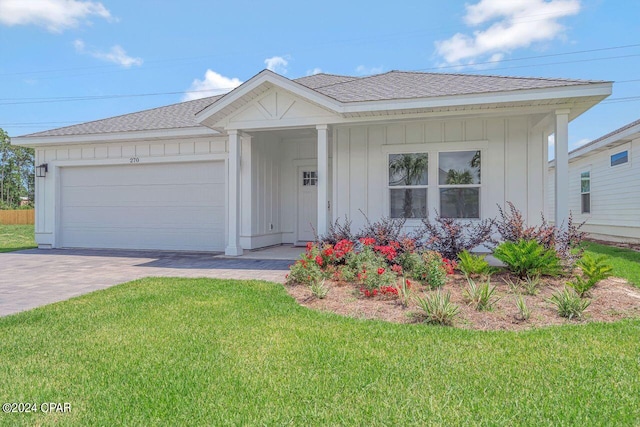 single story home with a garage and a front lawn