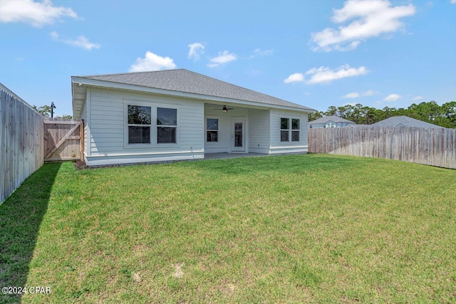 back of house with a lawn, ceiling fan, and a patio