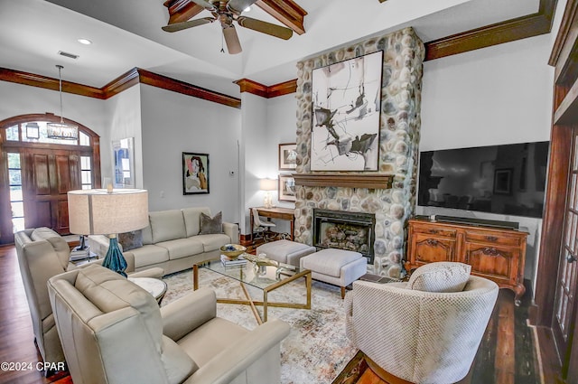 living room featuring a stone fireplace, ceiling fan, and dark hardwood / wood-style flooring