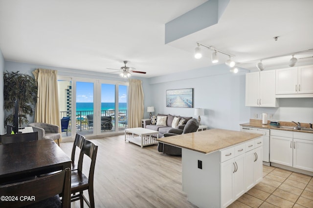 9860 S Thomas Dr Unit 519, Panama City, FL 32408 - kitchen featuring dishwasher, a ceiling fan, a sink, and open floor plan