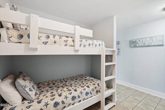 9860 S Thomas Dr Unit 519, Panama City, FL 32408 - bedroom featuring light tile patterned flooring and baseboards
