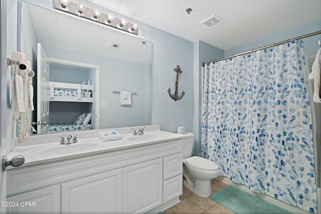 bathroom with a shower with curtain, tile patterned flooring, toilet, and vanity