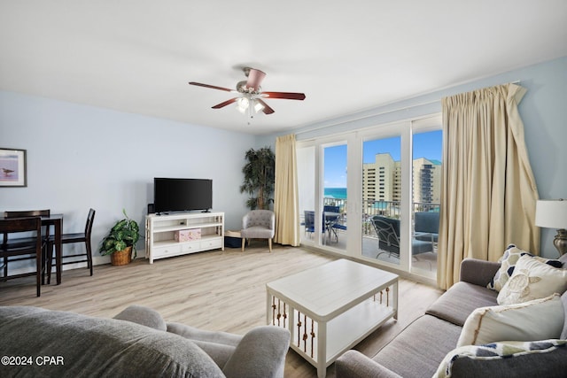 living room featuring ceiling fan and light hardwood / wood-style flooring