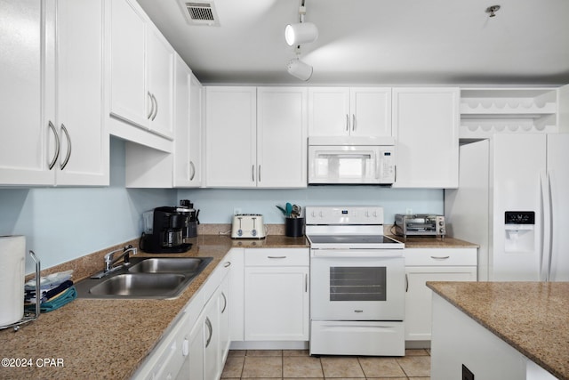 9860 S Thomas Dr Unit 519, Panama City, FL 32408 - kitchen with visible vents, white cabinetry, a sink, and white appliances