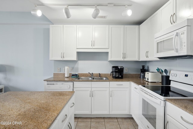 kitchen featuring track lighting, white appliances, light tile patterned floors, sink, and white cabinets