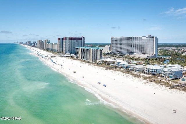 bird's eye view featuring a water view and a beach view