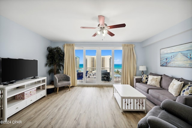 living room featuring ceiling fan and light hardwood / wood-style floors