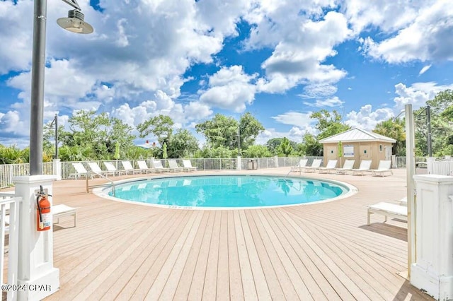 view of swimming pool with a deck