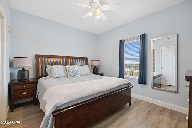 bedroom featuring light wood-type flooring and ceiling fan