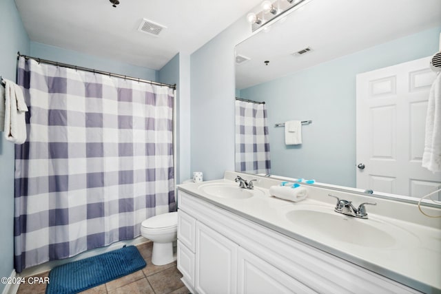 bathroom featuring vanity, toilet, a shower with curtain, and tile patterned floors