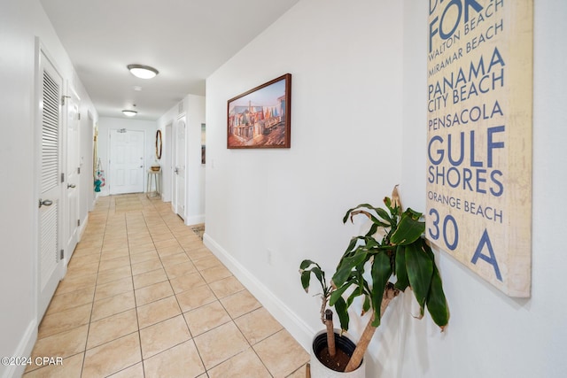 corridor featuring light tile patterned floors