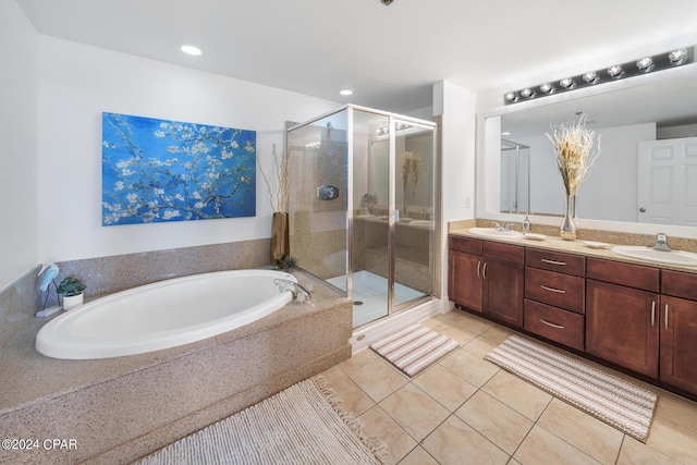 bathroom featuring vanity, tile patterned floors, and shower with separate bathtub