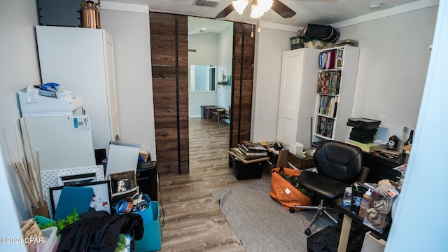 office featuring crown molding, ceiling fan, and wood-type flooring