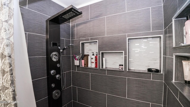 bathroom with a tile shower