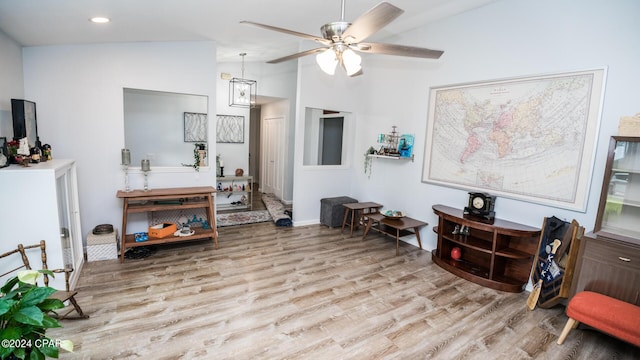 sitting room featuring ceiling fan, light hardwood / wood-style floors, and vaulted ceiling