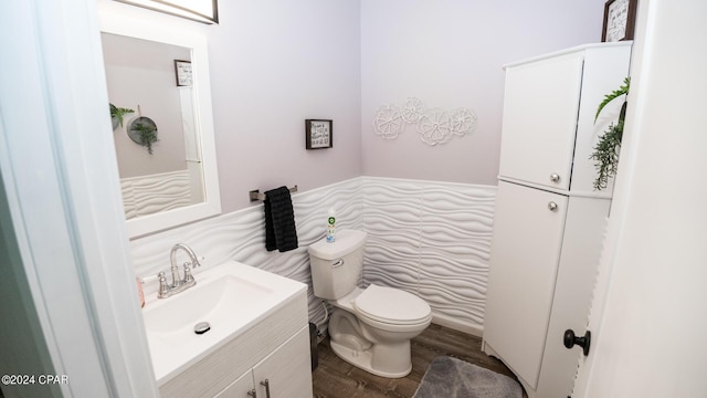 bathroom featuring hardwood / wood-style floors, vanity, and toilet