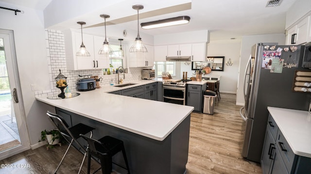 kitchen featuring white cabinets, kitchen peninsula, and sink