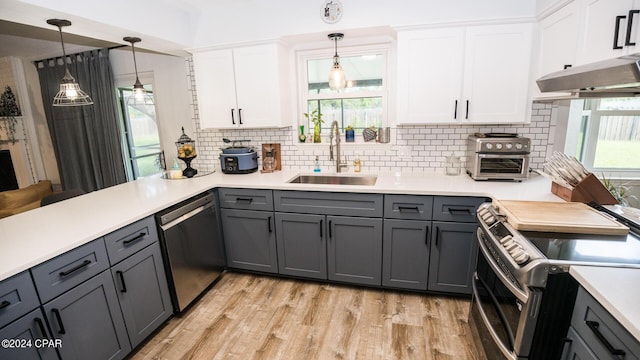 kitchen featuring sink, light hardwood / wood-style floors, gray cabinets, white cabinets, and appliances with stainless steel finishes