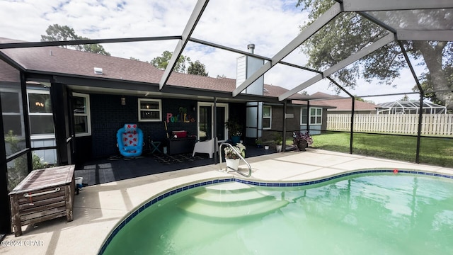 view of swimming pool with a lanai and a patio area