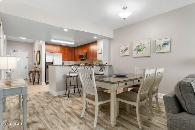 dining space featuring light hardwood / wood-style floors