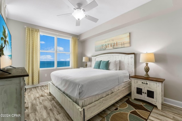 bedroom with ceiling fan and hardwood / wood-style flooring