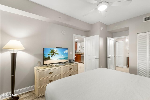 tiled bedroom featuring ceiling fan