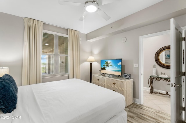 tiled bedroom with ceiling fan