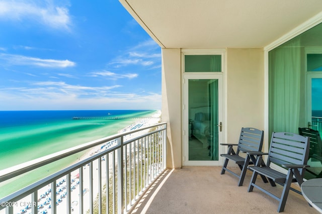 balcony with a beach view and a water view