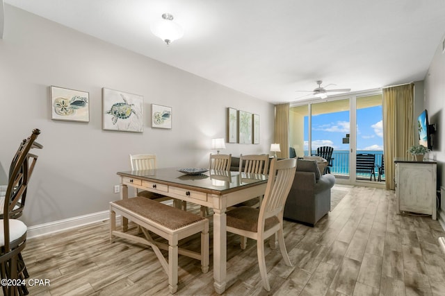 dining space featuring plenty of natural light, ceiling fan, floor to ceiling windows, and wood-type flooring