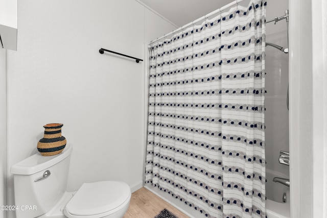 bathroom with toilet and hardwood / wood-style flooring