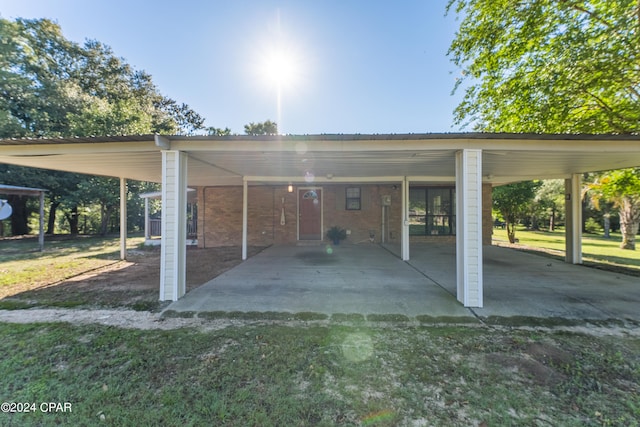 view of parking featuring a yard and a carport