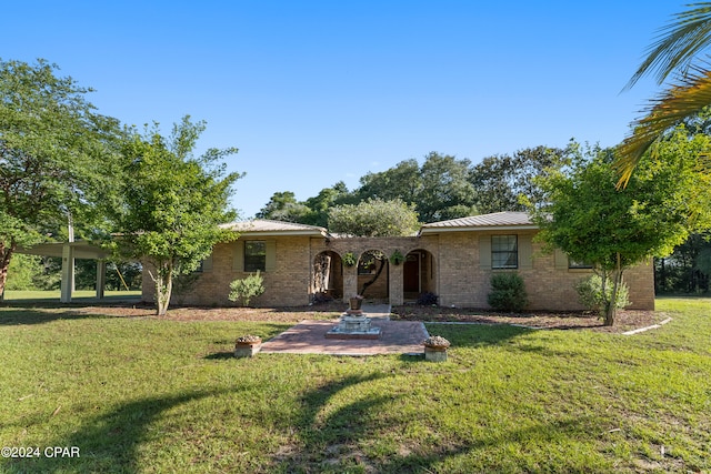 ranch-style house featuring a patio and a front lawn