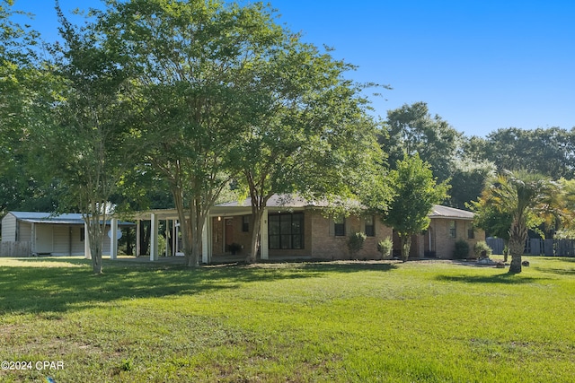 ranch-style house with a front lawn