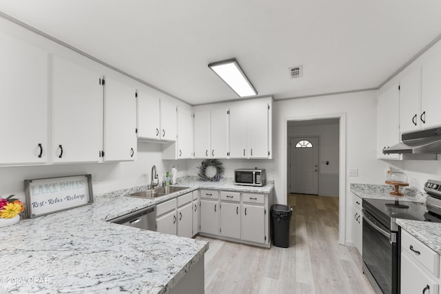 kitchen with appliances with stainless steel finishes, light hardwood / wood-style flooring, white cabinets, sink, and light stone countertops