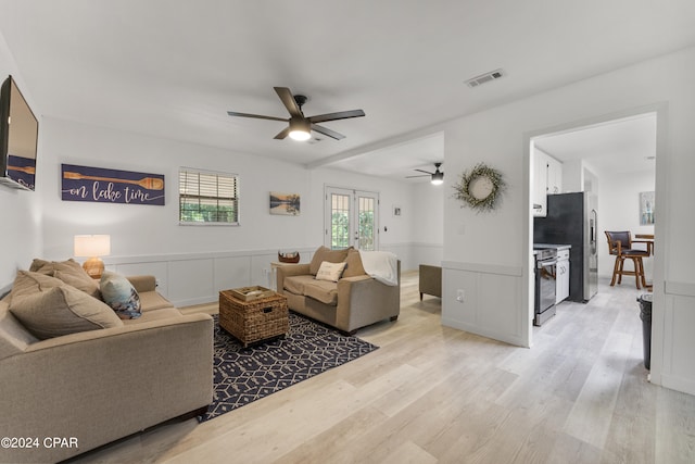 living room with french doors, light hardwood / wood-style flooring, and ceiling fan