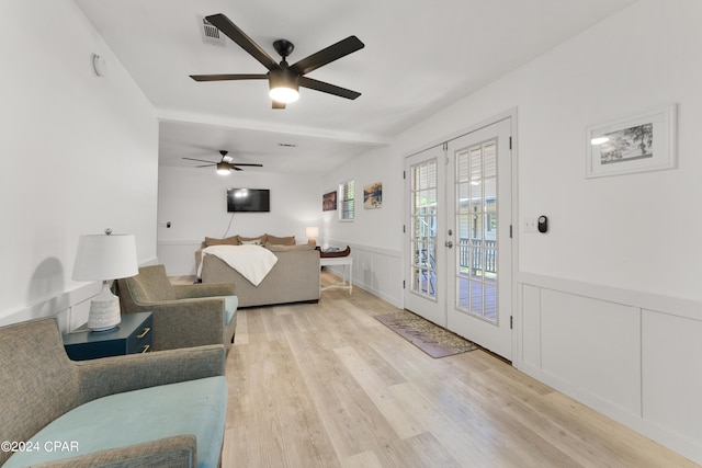 living room with french doors, light wood-type flooring, and ceiling fan