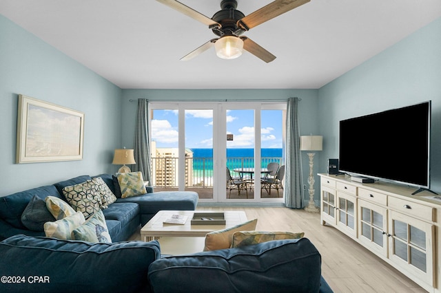 living room with light hardwood / wood-style floors and ceiling fan