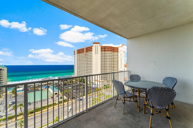 balcony featuring a water view and a beach view