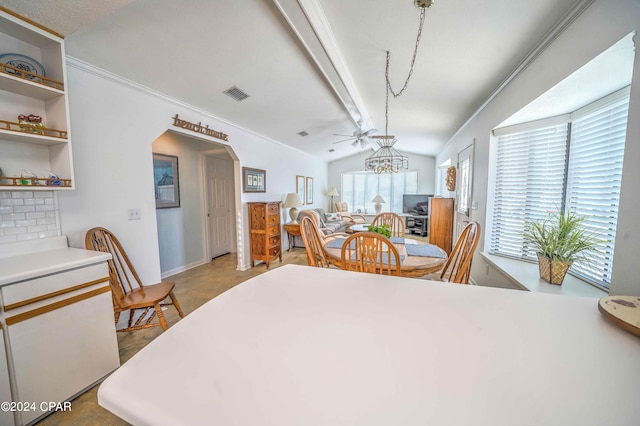 dining area with ceiling fan and vaulted ceiling