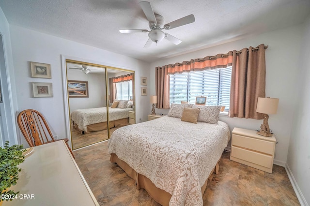 bedroom with ceiling fan, tile patterned flooring, a closet, and a textured ceiling