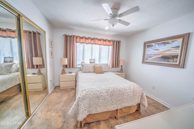 bedroom with light hardwood / wood-style floors, a closet, and ceiling fan