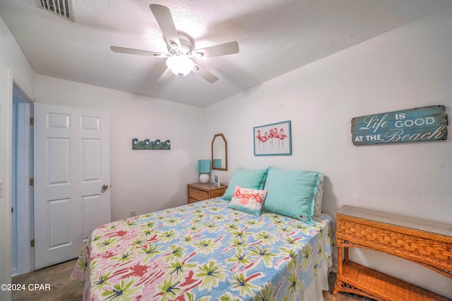 bedroom with a textured ceiling and ceiling fan