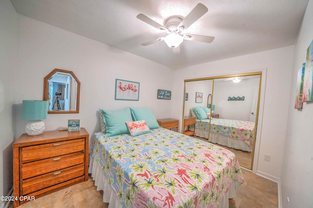 bedroom with a textured ceiling, a closet, and ceiling fan