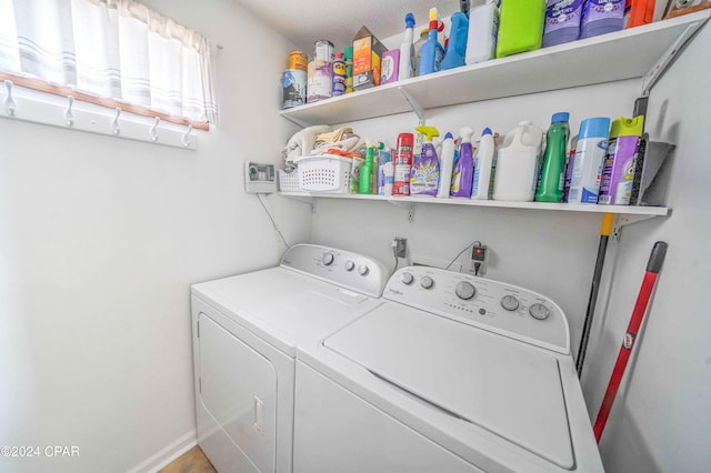 laundry area featuring washing machine and dryer and a textured ceiling