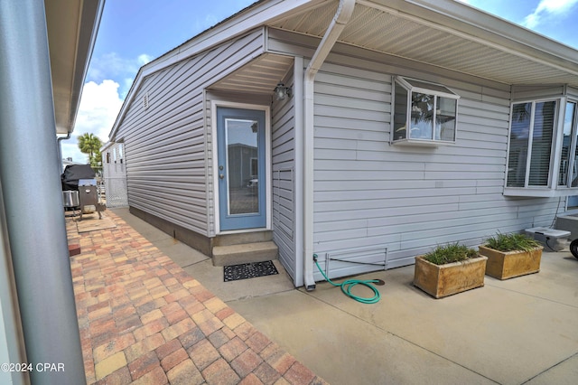 view of side of property featuring a patio area